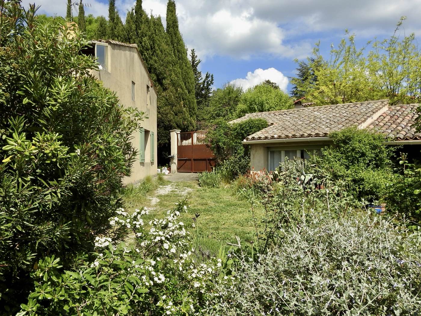 Sun-lit stone courtyard of a French farmhouse